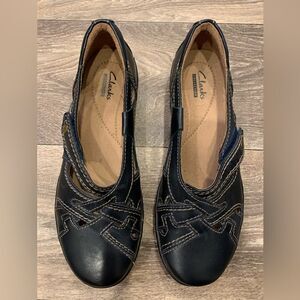 Clark’s ladies flats.  Size: 7.  Dark navy blue.  Velcro closure.  Leather.